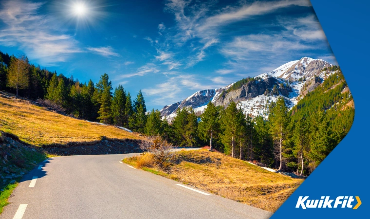Isolated stretch of sun-kissed road in Col de la Bonette in the French Alps.