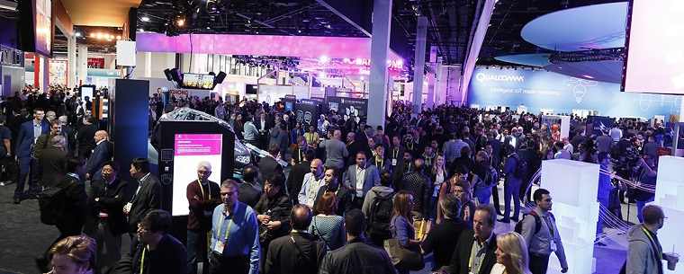 The CES 2017 show floor, busy with people, lights, and billboards.