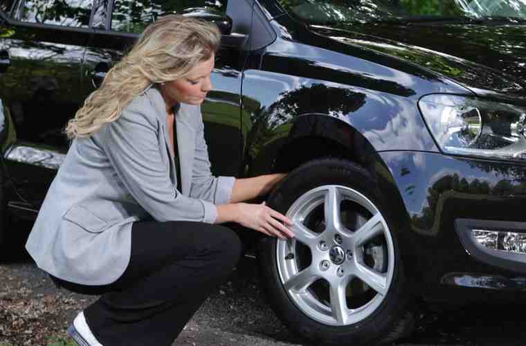 woman checking tyres