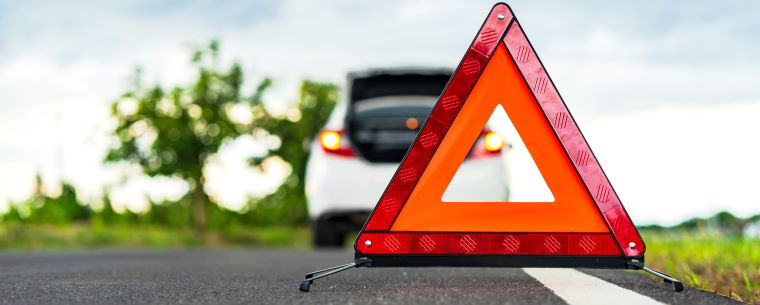 Broken down car with a warning triangle