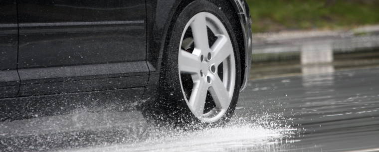 Car Aquaplaning over Wet Road Surface
