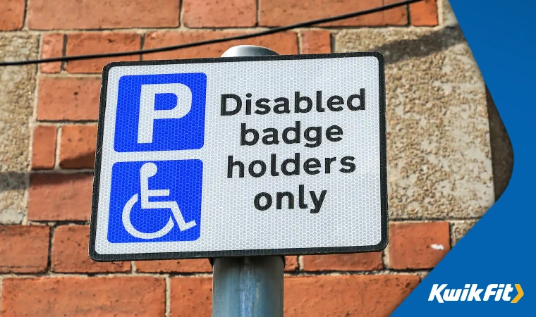 A road sign that says 'Disabled badge holders only'.