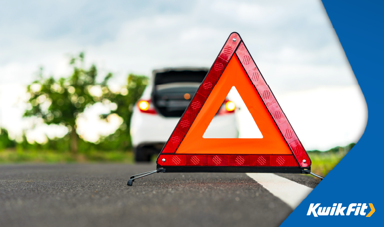 Warning triangle set up behind vehicle to warn road users of an incident.