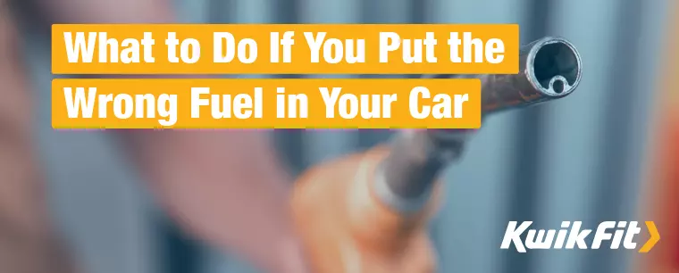 A person holds a fuel pump nozzle in preparation for refuelling their car.