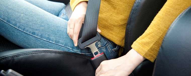 Woman fastening seatbelt 
