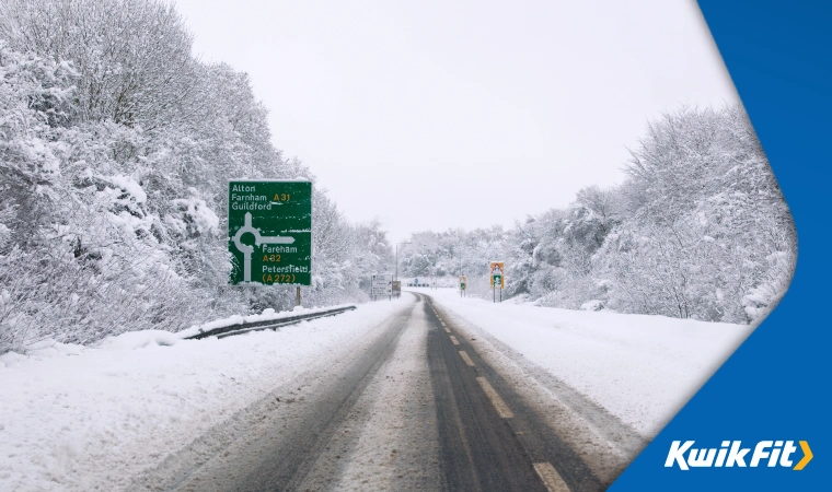 An empty road after heavy snow  a lot appears to have melted and refrozen into icy slush.