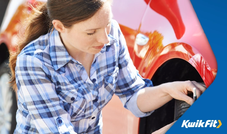 a mum checking the tyre pressure on a car