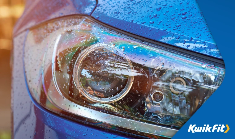 Close up of car headlights in the rain.