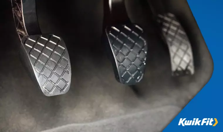 Close up of grey metal car pedals.