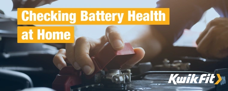 Close up of a person taking a battery terminal cover off to inspect the terminal connections.