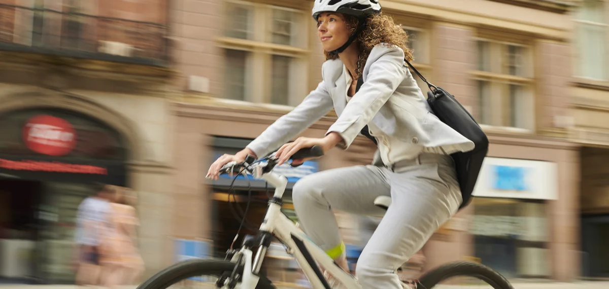 cyclist wearing a helmet and riding a bike in a city