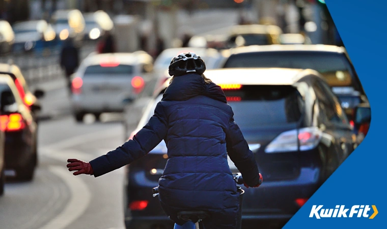 Cyclist navigating road traffic.