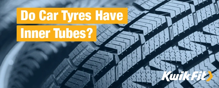 Car tyres with intricate tread patterns up close.