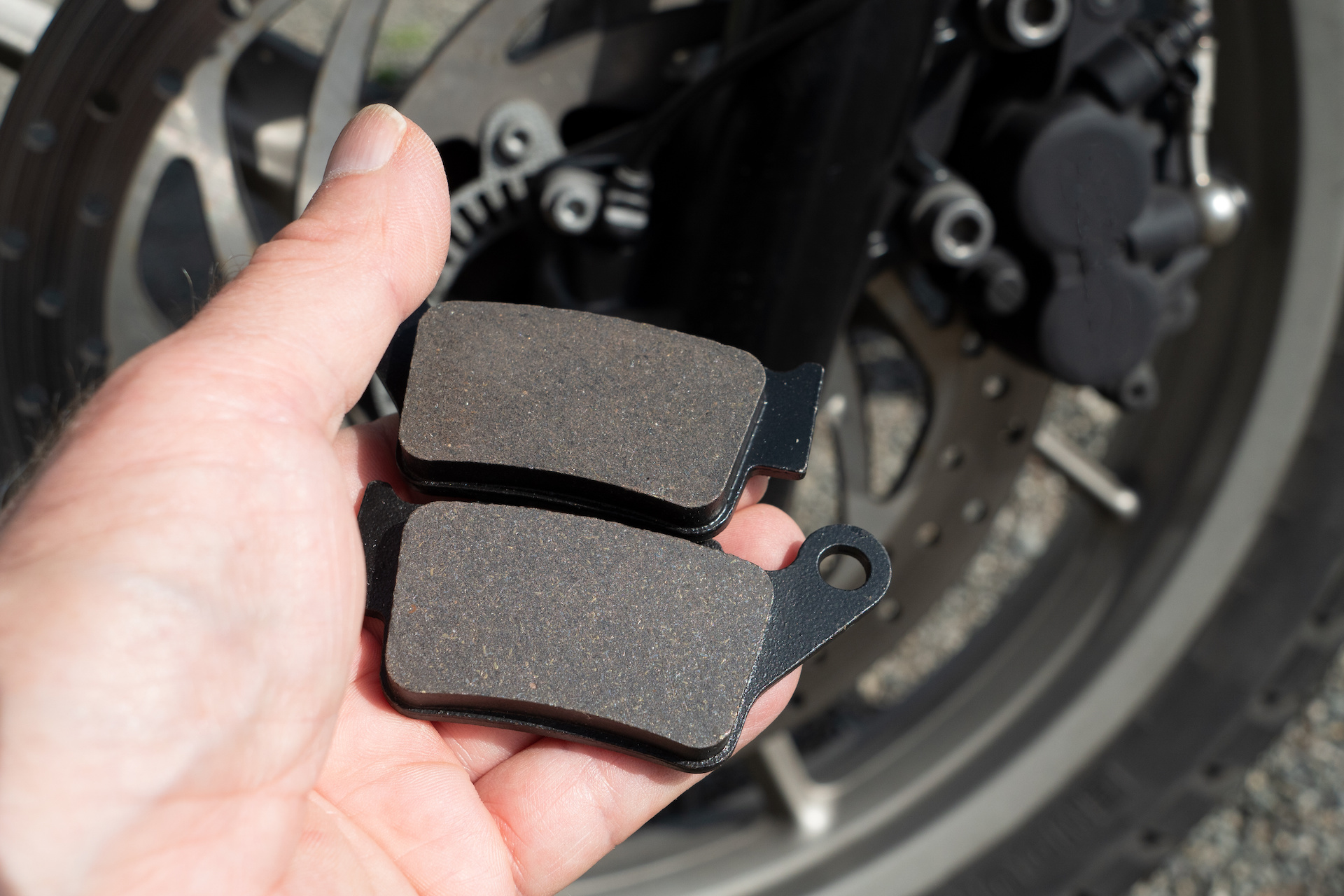 Fresh brake pads in a persons hand.