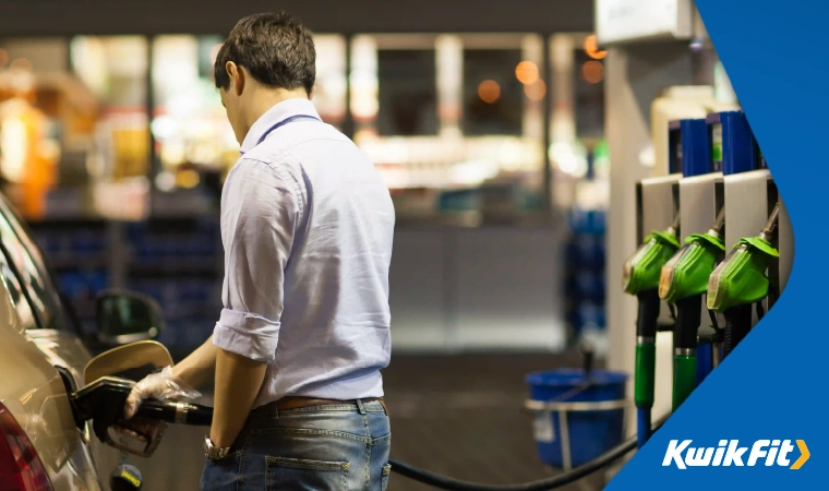 A person refuelling a car in a petrol station.