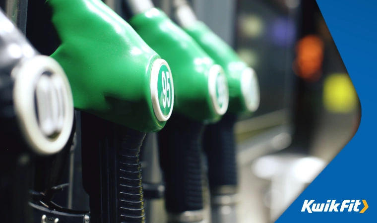 Closeup of unleaded and diesel fuel nozzles at a petrol station.