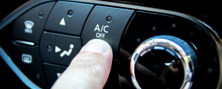Pressing the air conditioning button inside a car