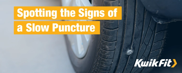  A car tyre with a nail wedged into the rubber, causing a slow puncture.