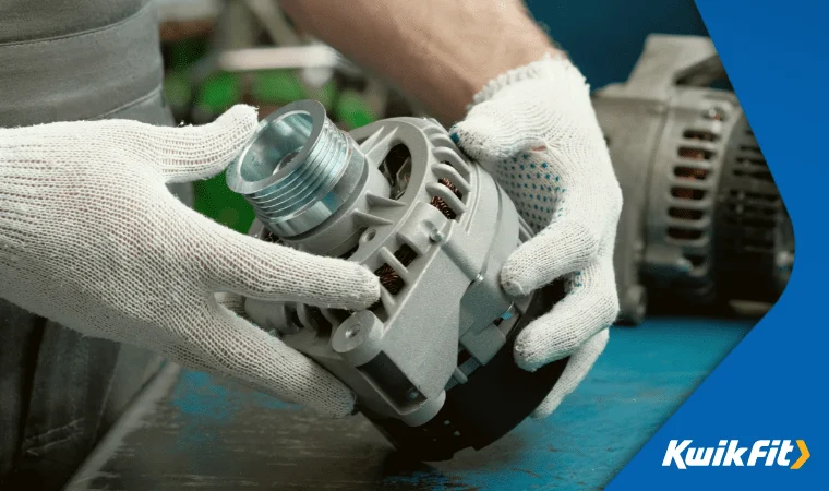 A technician inspects a disassembled alternator for cleaning & fault-finding