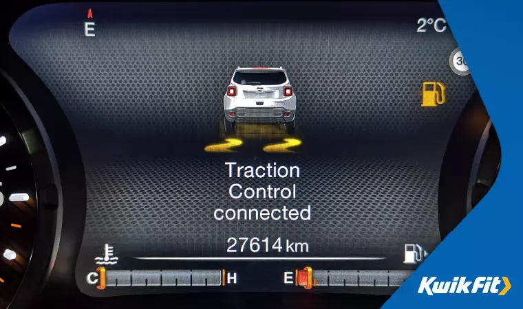 Traction control symbol showing on a dashboard display.
