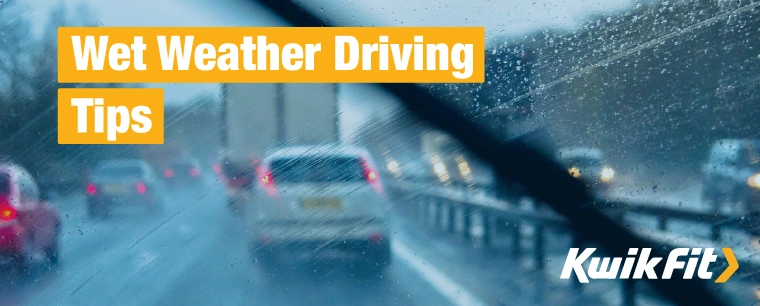 Driving on a motorway in the rain, some congestion due to cars slowing down for safety.