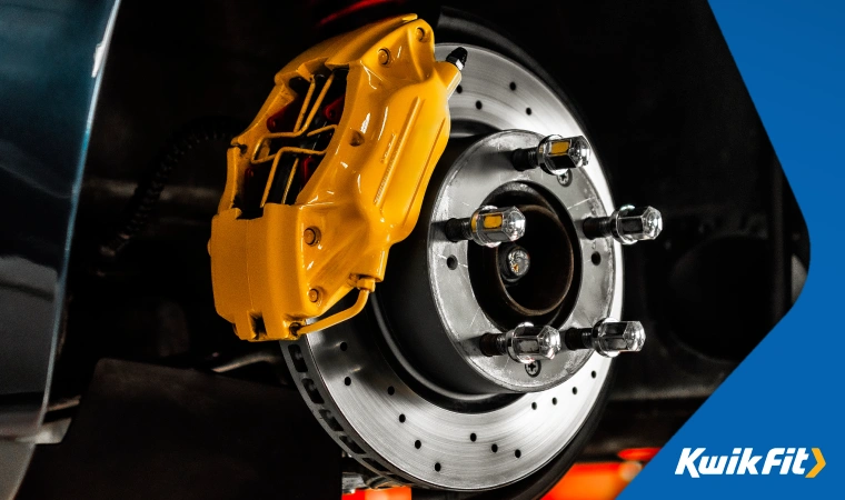 Exposed brake disc shows bright yellow brake caliper with ABS fitted.